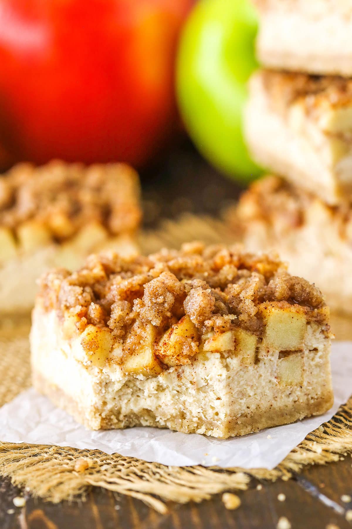 An Apple Streusel Cheesecake Bar with a bite removed