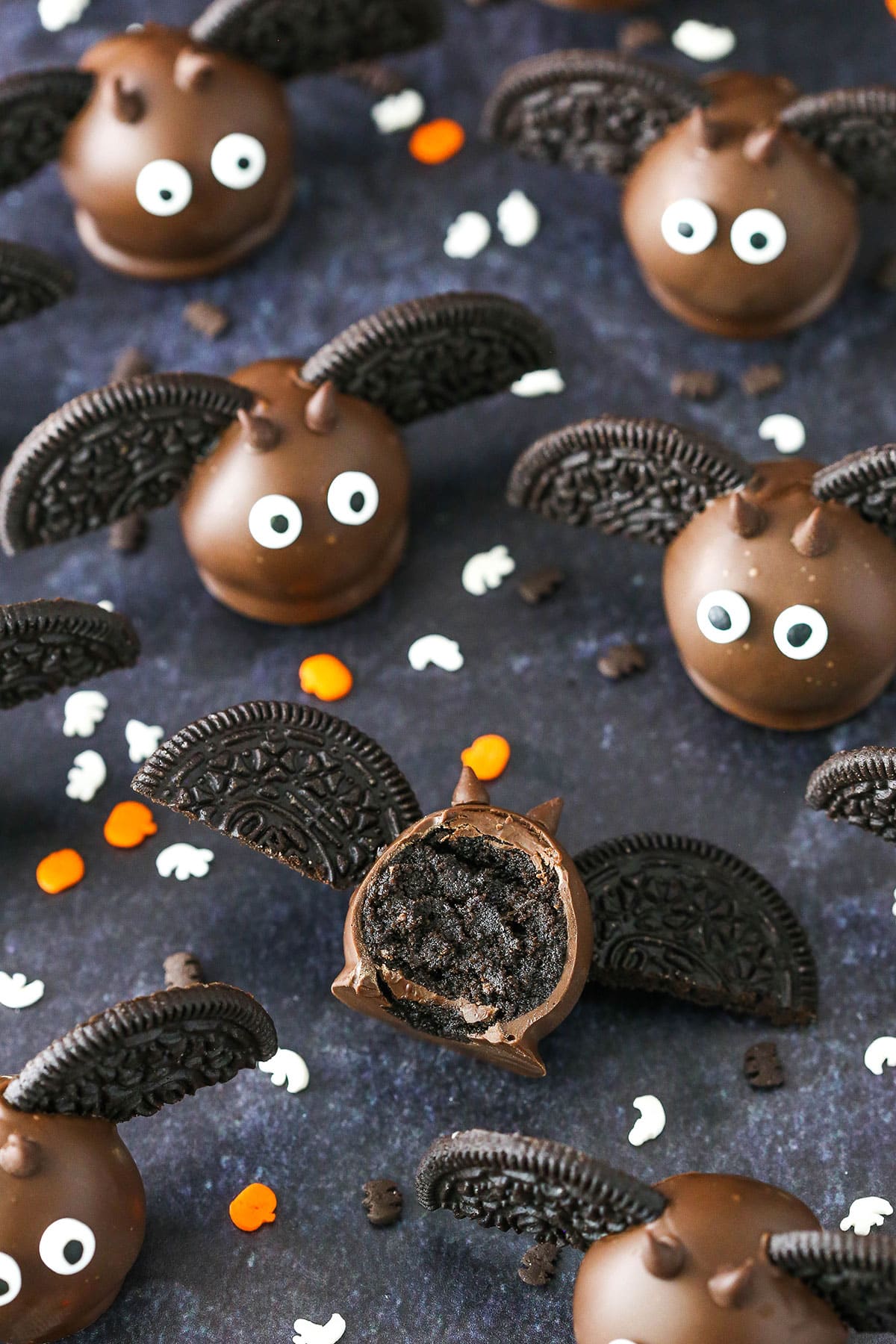 Bat Oreo Cookie Balls with Oreo wings spread out on a black table top