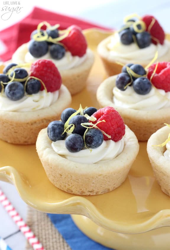Berry Lemon Cheesecake Cookie Cups on a yellow cake stand