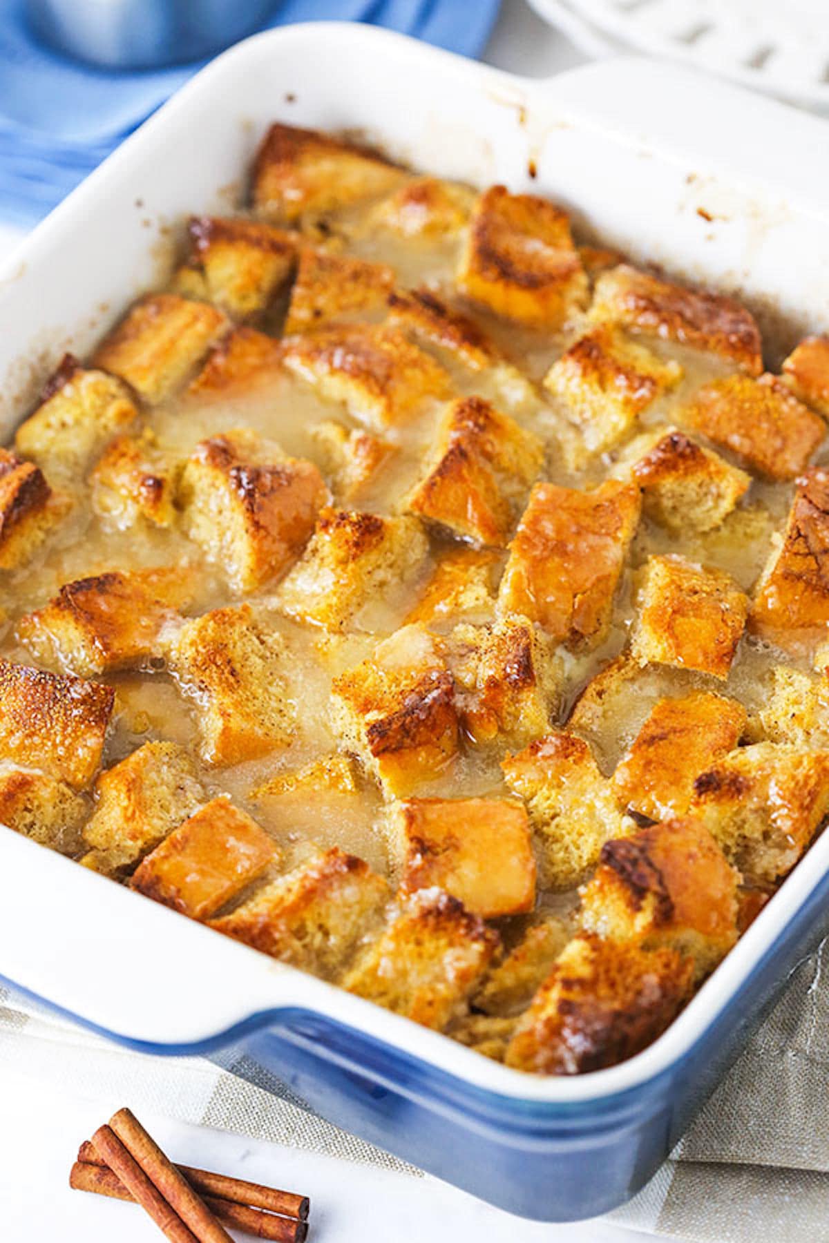 Homemade bread pudding in a white and blue pan.
