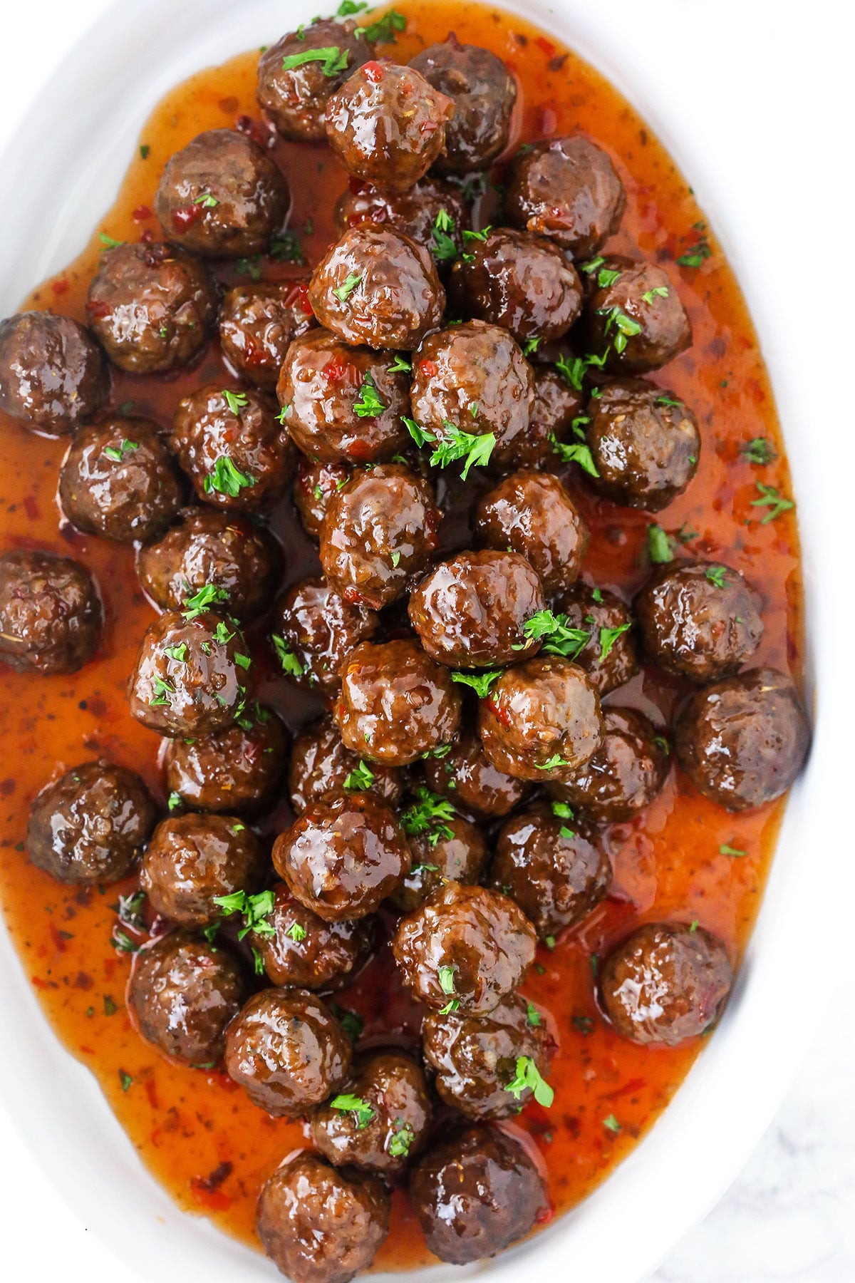 Grape jelly meatballs and sauce in white dish