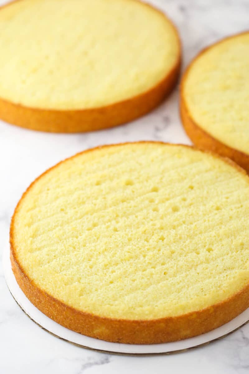 Three lemon cakes ready to be stacked, filled, and frosted.