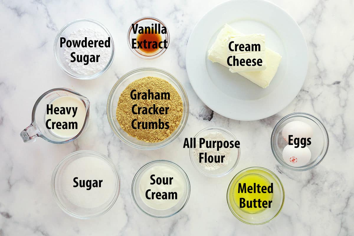 Ingredients for mini cheesecakes separated into bowls.