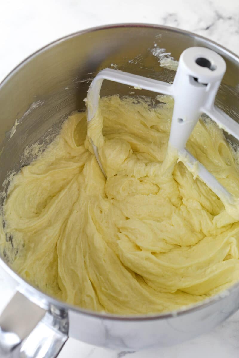 Adding eggs to vanilla cake batter.