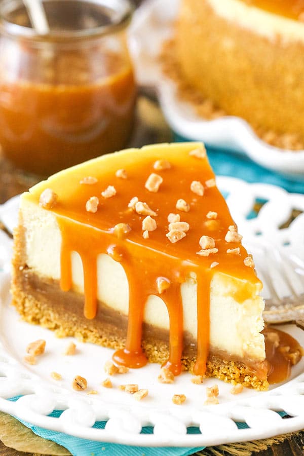A slice of cheesecake covered with caramel topping