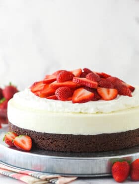 Strawberry brownie cheesecake on a serving platter.